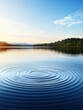 © nattapon - A serene lake scene captures tranquil water ripples under a clear blue sky, surrounded by lush greenery, ideal for promoting relaxation, nature-themed projects, or wellness content,