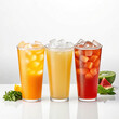 © setan cell - Three refreshing iced fruit teas in tall glasses with ice cubes and fruit slices.