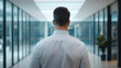 © NaphakStudio - professional leader walking through modern open plan office, exuding confidence and focus.