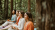 © Postmodern Studio - Group of diverse women meditating in forest setting with calm expressions