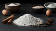 © Jula Isaeva  - pile of flour surrounded by cinnamon sticks, eggs, and baking ingredients on a dark rustic background