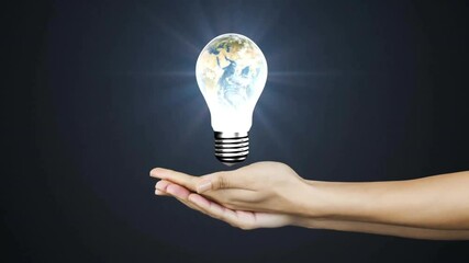 Poster - Holding glowing light bulb with Earth inside, hand creating animation concept