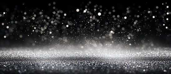 Wall Mural - Sparkling silver glitter on black background with bokeh.