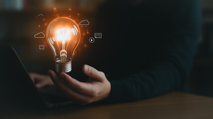 Poster - illuminating innovation: a person's hand cradles a glowing light bulb, symbolizing innovative ideas 