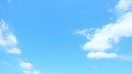 Wall Mural - A timelapse video of calming blue sky, where soft, white clouds drift aimlessly, creating a sense of relaxation and peace.
