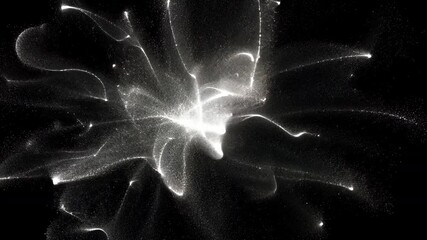 Poster - Brilliant white particles radiating from central origin, expanding across dark background with glowing, ethereal energy suggesting cosmic stardust spreading through deep space