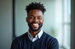 © miss irine - Smiling black guy poses for photo, looks at camera. Indoor portrait of confident african american businessman. Male entrepreneur, manager, office worker, employee, company member. Business portrait.