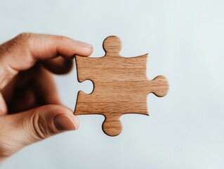 Aufkleber - Minimalist Problem-Solving Aesthetic Wooden Puzzle Piece in Hand - Innovative Business Strategy, Creative Problem Resolution and Collaborative Design Metaphor