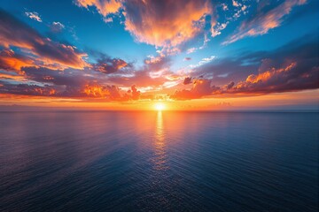 Aufkleber - Vibrant ocean sunset with fiery clouds and serene water reflecting light.