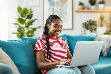 Aufkleber - Woman working on laptop on a blue couch.