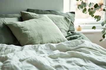Aufkleber - Cozy bedding arrangement in a serene bedroom with natural light and plants
