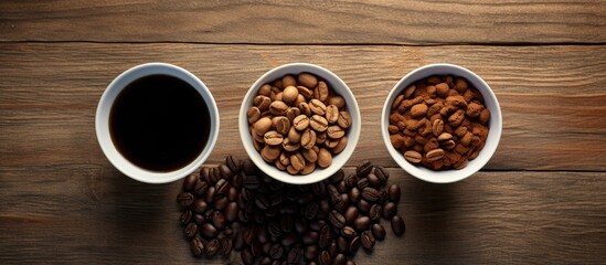 Aufkleber - Top view of three white bowls containing black coffee, whole coffee beans, and ground coffee on a dark wooden table with ample copy space