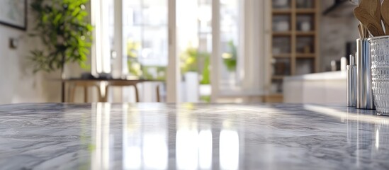 Aufkleber - Modern kitchen interior with sleek marble countertop in foreground, sunlight filtering through large windows, greenery enhancing ambiance.