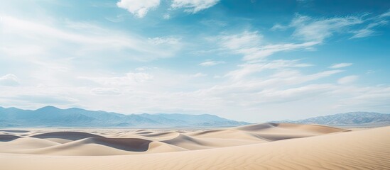 Aufkleber - Vast Tottori sand dunes in soft beige tones under a bright blue sky with wispy clouds create an expansive desert landscape perfect for copy space.