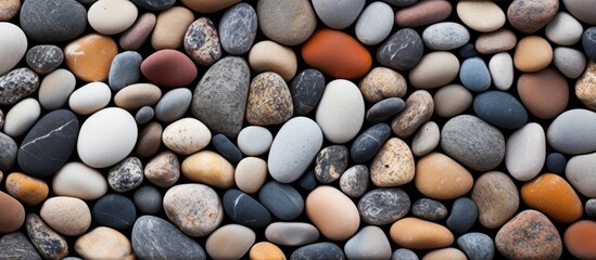 Aufkleber - Colorful assortment of smooth sea pebbles in various shades of grey, beige, white, and brown arranged in a natural random pattern.