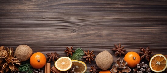 Poster - Rustic wooden background adorned with vibrant oranges, dried citrus slices, star anise, and pine, creating a warm, seasonal decor.