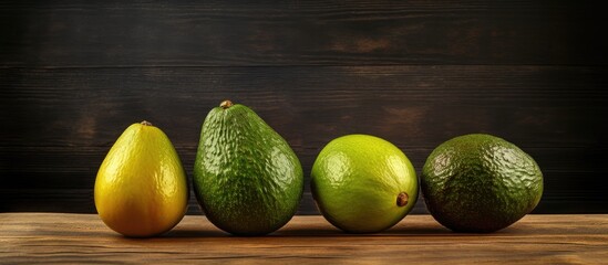 Aufkleber - Fresh avocados in various shapes and sizes arranged on a rustic wooden surface with dark background showcasing vibrant green hues and copy space