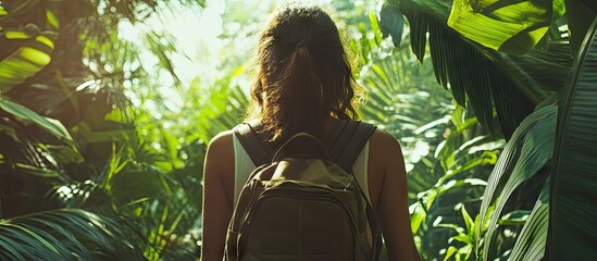 Poster - Young woman with backpack exploring lush green jungle, sunlight filtering through foliage, vibrant greens in background, serene outdoor adventure.