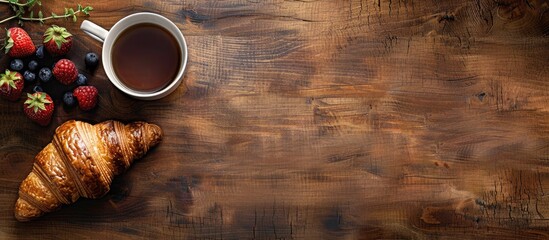Poster - Breakfast scene featuring a brown wooden table displaying a croissant, a cup of black coffee, and fresh berries with ample copy space on the right.
