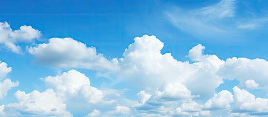 Poster - Vast blue sky filled with fluffy white clouds creating a serene and picturesque scene with soft gradients of blue and white throughout the image