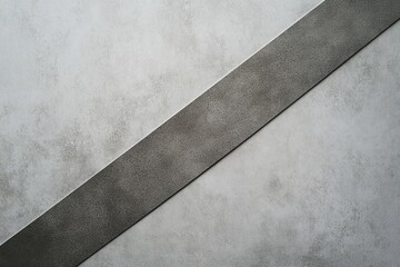 Poster - Monochromatic Abstract: An eye-level shot showcasing a minimalist composition featuring a dark band slanting diagonally across a textured grey plane