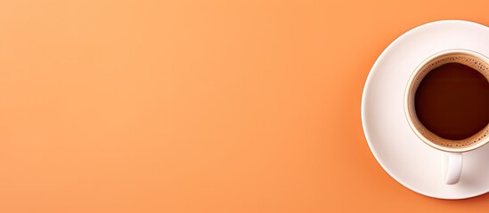 Aufkleber - Top view of a white coffee cup filled with dark coffee on an orange background with ample clear copy space on the left side for text placement