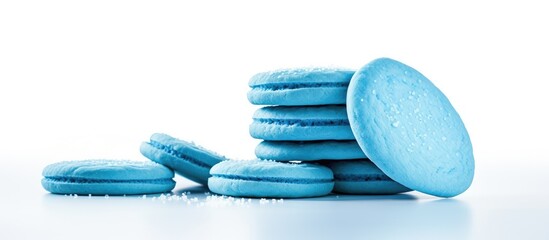 Poster - Stacked blue sugar cookies on a white background with a smooth texture ideal for dessert graphics and food-themed designs, ample copy space.