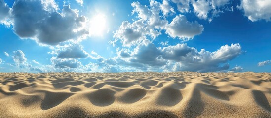 Aufkleber - Vast sandy desert under a bright blue sky filled with fluffy white clouds, sunlight illuminating undulating sand dunes in a serene landscape.