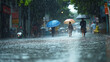 © Jhati - Rainy city street scene people walking umbrellas wet asphalt urban downpour summer monsoon day grey