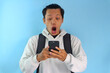 © Lailar Studio - Asian male student college looking at screen mobile phone with surprised expression