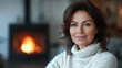© Руслан Галиуллин - Portrait of beautiful 50 years old woman in white sweater at home in the background hearth
