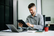 © Nuttapong punna - business man executive manager looking at laptop watching online webinar training or having virtual meeting video conference