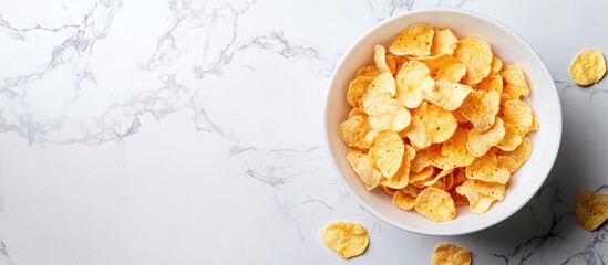 Poster - Bowl of crispy cornflakes on a white marble countertop with scattered flakes around, featuring a soft light background for a fresh morning vibe