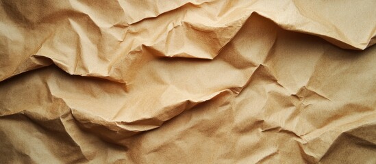 Aufkleber - Crumpled brown paper texture featuring light tan and darker shades, showcasing intricate folds and shadows in a horizontal layout.