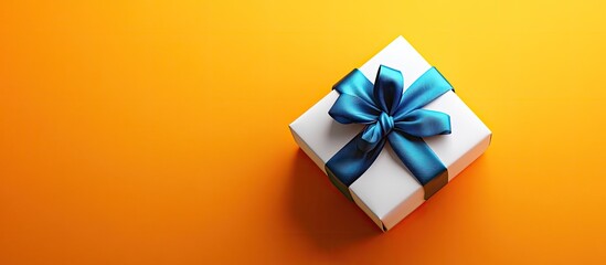 Poster - Gift box wrapped in white paper with a satin blue bow positioned on the right against a vibrant yellow orange background ideal for celebrations
