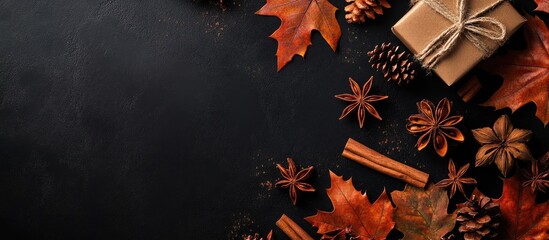 Aufkleber - Autumn decorative flat lay with cinnamon sticks, star anise, pine cones, and vibrant orange leaves on a dark textured background with gift box