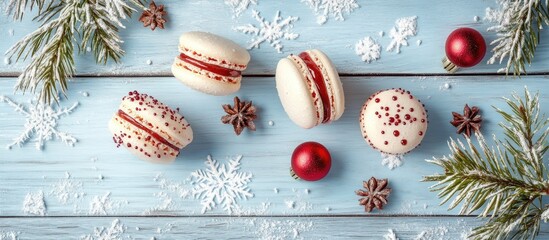 Poster - Elegant Christmas macarons in white and red on light blue wooden table with pine branches, snowflakes, and red ornaments, ample copyspace.