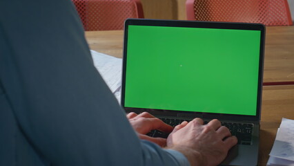 Poster - Unrecognizable businessman working chroma key laptop in modern workplace closeup