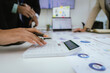 © Witoon - A team of professionals work together in an office to analyze financial charts, market strategies and work as a team to drive business growth and success.