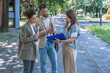 © Srdjan - Brainstorming. Group of young innovative business people, businessman and businesswoman standing out of office building, preparing for presentation at staff meeting with corporation management.