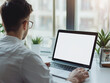 © Imasha - Professional Man Using Laptop with Blank Screen for Design or Presentations, businessman working on laptop