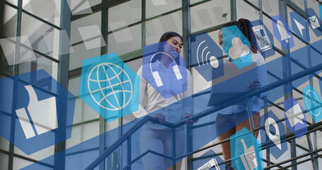 Poster - Image of media icons over diverse female colleagues talking in office
