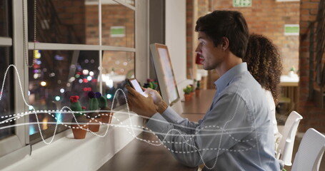 Poster - image of diagrams over diverse colleagues using smartphone in office