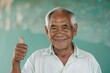 © Markus Schröder - Portrait of a happy man in his 60s showing a thumb up over soft teal background
