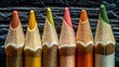 © iskar suhadi - Close-up of sharpened colored pencils on textured dark wood