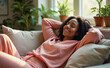 © D.Kaminsky - african-american woman in pink long-sleeved top toprelaxing on a couch