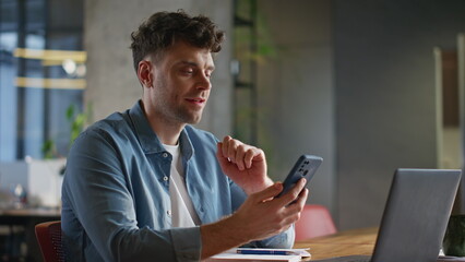 Poster - Relaxed man scrolling smartphone feed enjoying break at private cabinet closeup