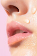 © Juiy - close up of hydrated cheek and lips with water droplets on smooth skin, highlighting freshness and skincare