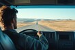 © Роман Булатов - A person drives a truck along a vast highway surrounded by rolling hills, bathed in warm light as the sun sets in the background, creating a serene atmosphere