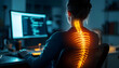 © Fatima - Person sitting in an office chair with their spine highlighted, working on a computer